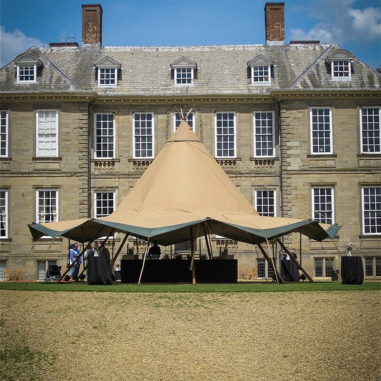 Tipi set up in front of a stately home