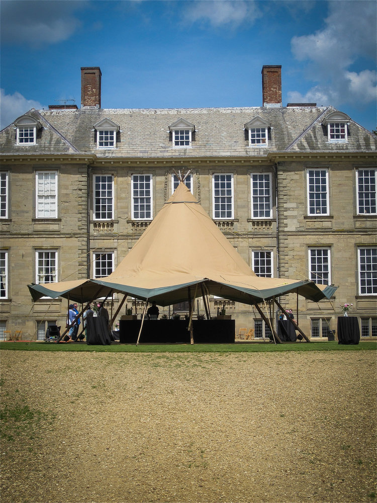 Tipi set up in front of a stately home